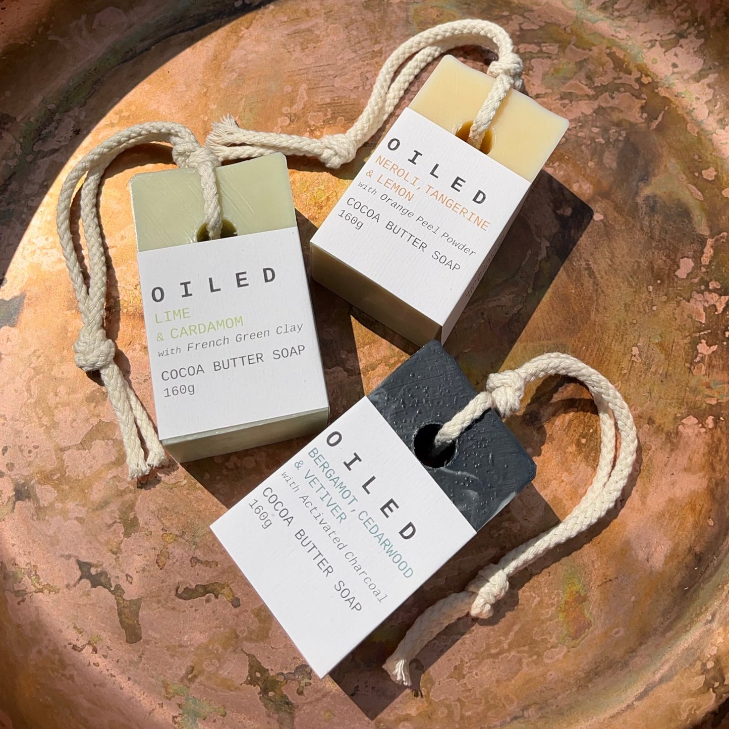 Three bars of Oiled soap on a rustic metal surface