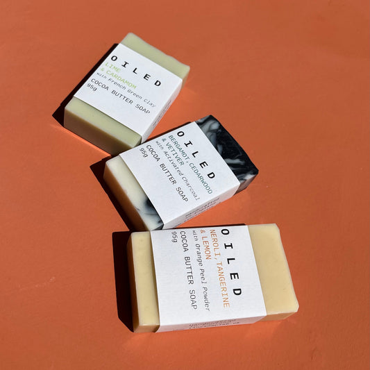 Three bars of Oiled soap on an orange background