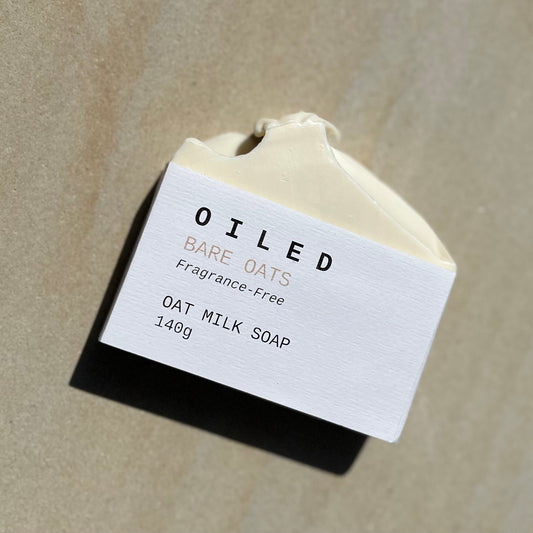 Oiled Bare Oats oat milk soap on a beige background