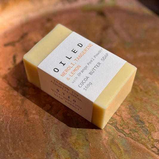 Bar of OILED soap with a label on a copper surface