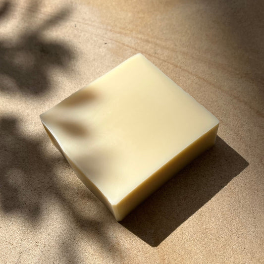 Bar of soap on a textured surface with natural light